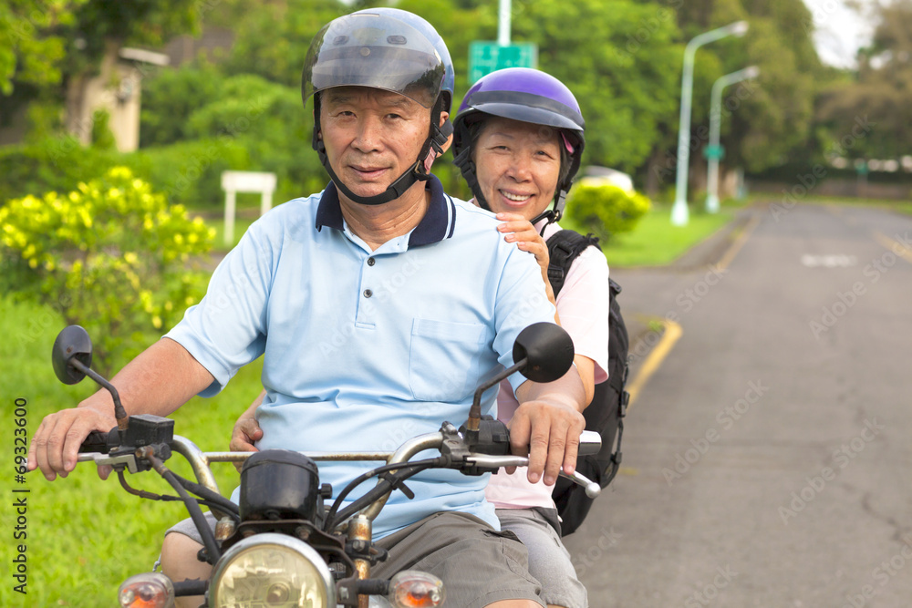 senior couple drive motorcycle to travel