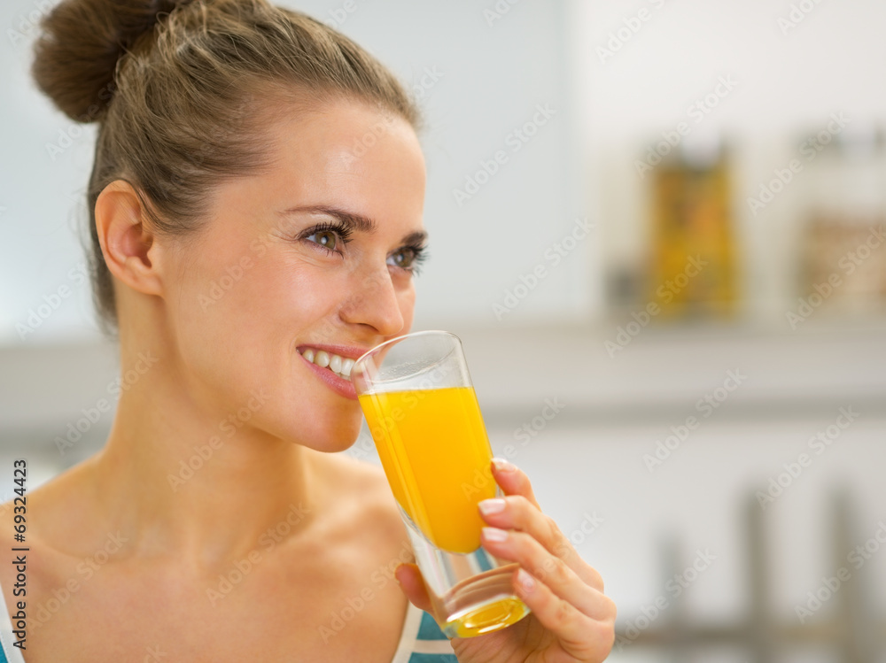 Portrait of happy young woman drinking fresh orange juice Portrait of happy young woman drinking fresh orange juice