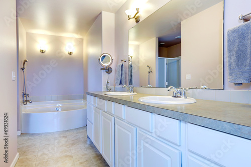 Refreshing light lavender bathroom with white cabinet