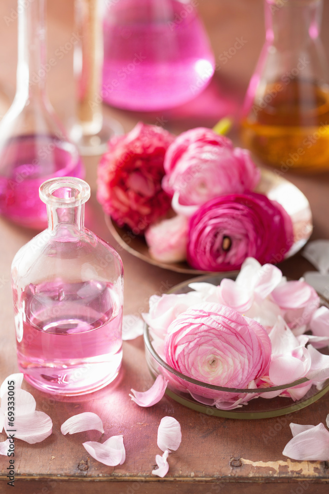 alchemy and aromatherapy set with ranunculus flowers and flasks alchemy and aromatherapy set with ranunculus flowers and flasks