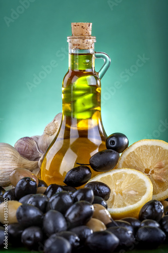 Healthy olive oil with black and green olives, lemon and garlic