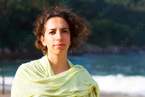 Konstfotografi Young beautiful sad woman with curly hair outside