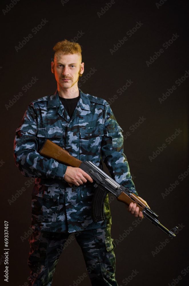 Man in camouflage clothing with a gun Man in camouflage clothing with a gun