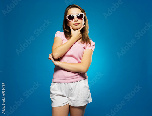 Thoughtful trendy young girl in sunglasses