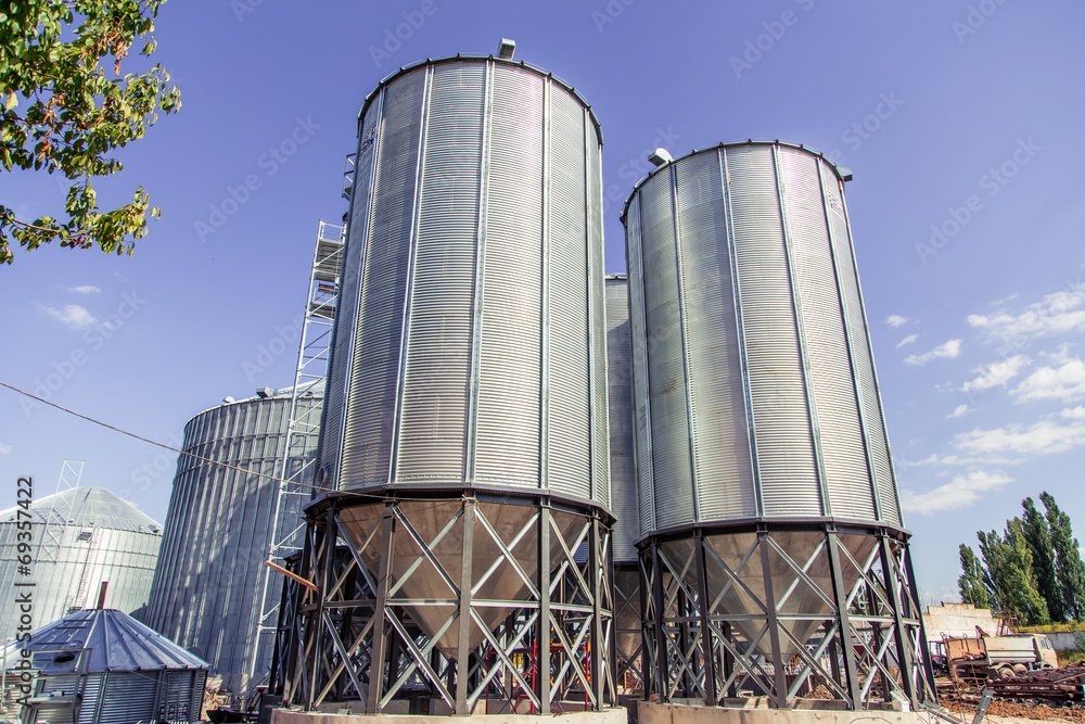 Background, metal barrels granaries on the sky background