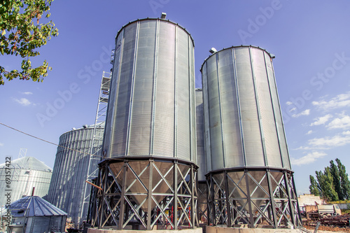 Background, metal barrels granaries on the sky background
