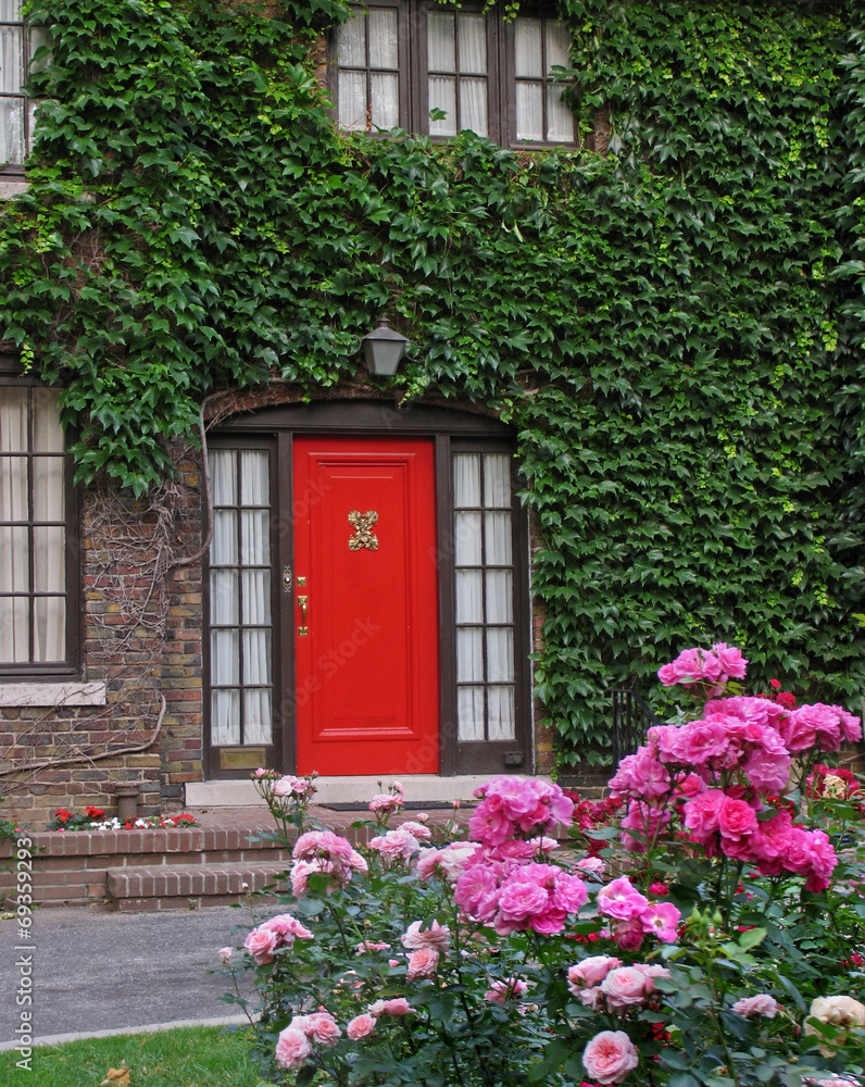 red front door with vines and roses