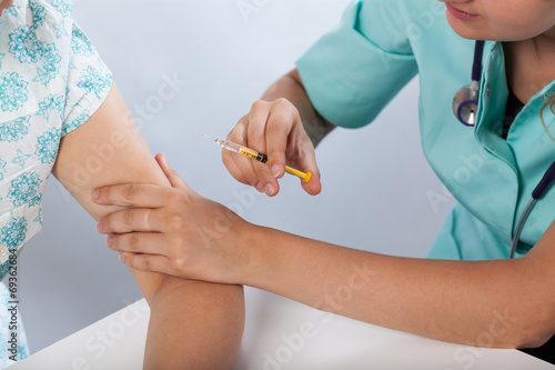 Doctor inecting patient's hand