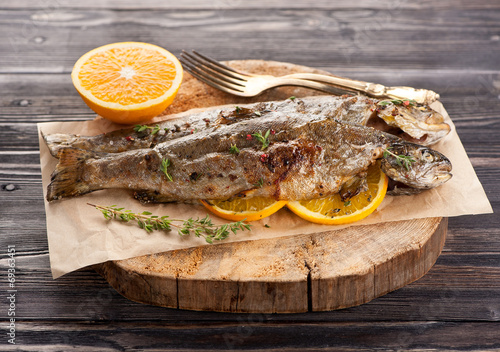 Baked trout fish with thyme and orange