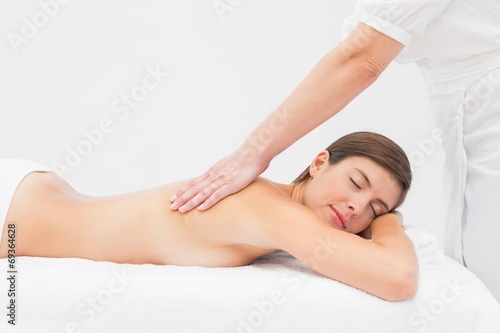 Attractive woman receiving back massage at spa center