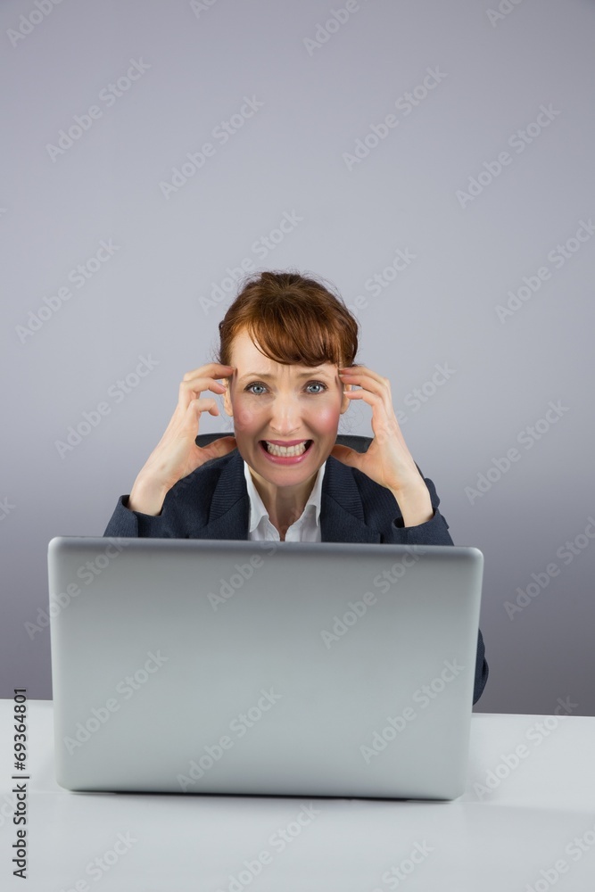 Stressed businesswoman working on laptop Stressed businesswoman working on laptop
