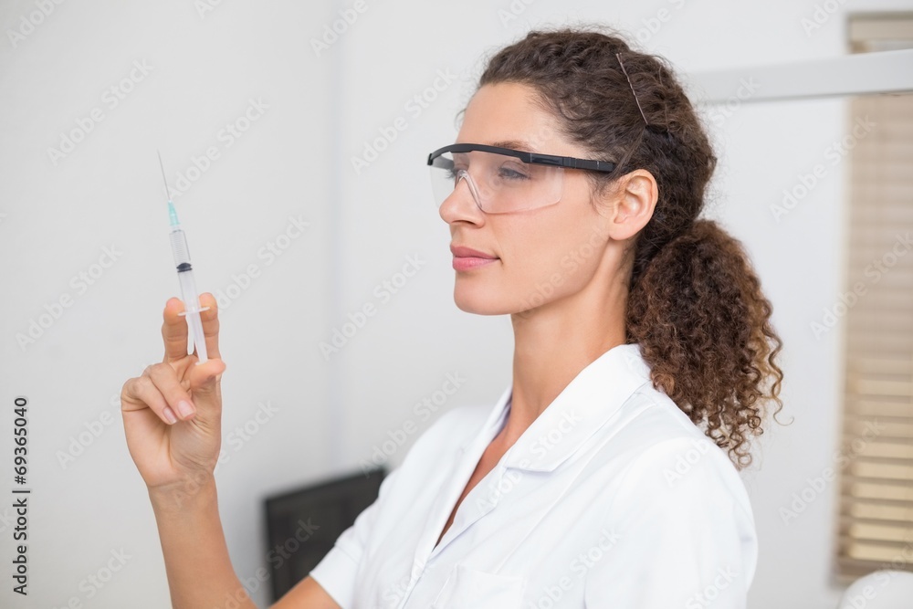 Dental assistant preparing an injection Dental assistant preparing an injection