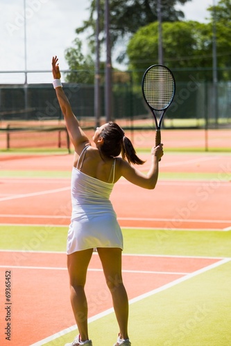 Pretty tennis player about to serve