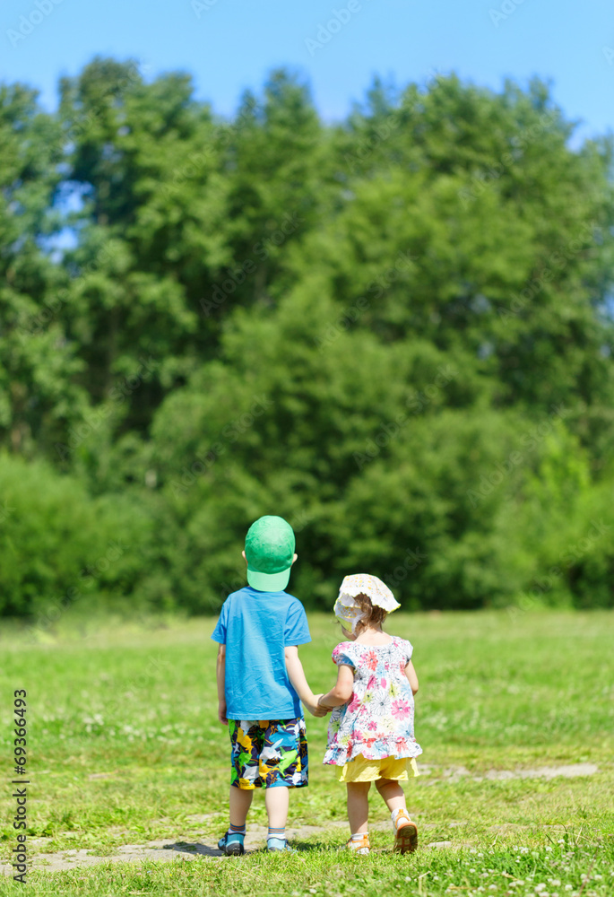 Obraz premium Little boy and girl hand in hand