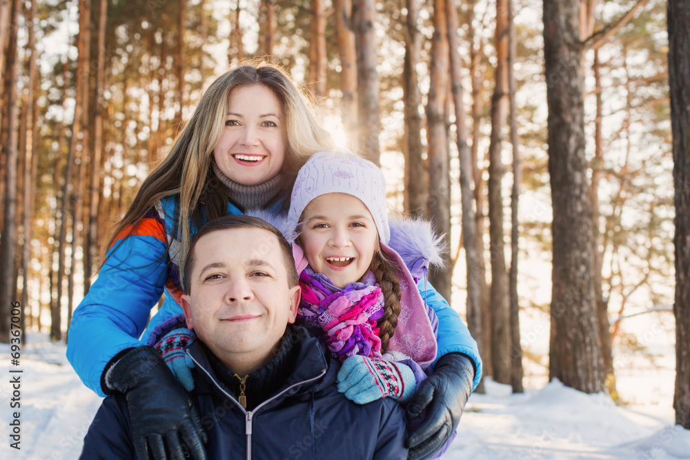 happy family in winter forest