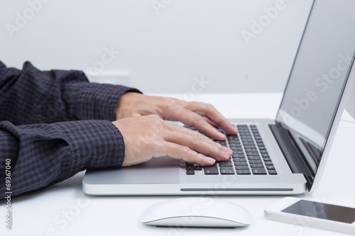 Man hands typing on laptop computer