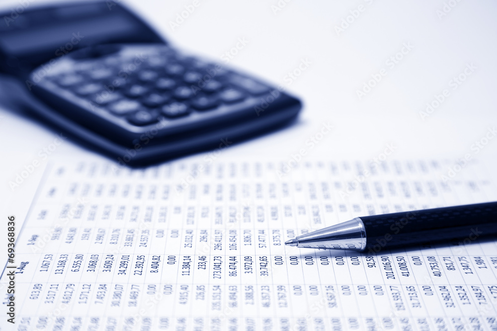 Financial accounting. Pen, calculator and calculation sheet Financial accounting. Pen, calculator and calculation sheet