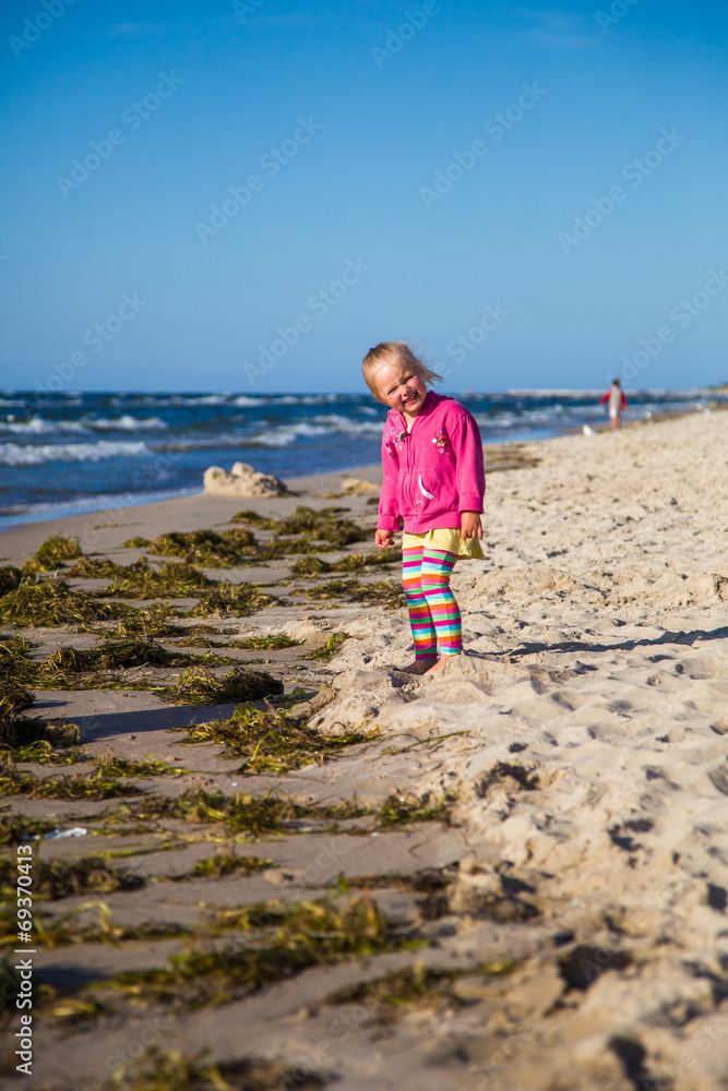 Infant preschool girl playing on a beach Infant preschool girl playing on a beach