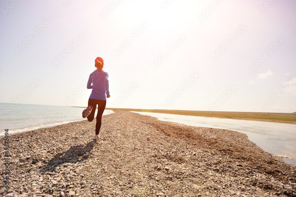  Runner athlete running on stone beach of qinghai lake
