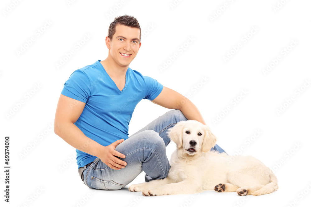 Man chilling out with his puppy seated on floor Man chilling out with his puppy seated on floor