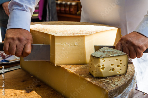 Man cutting piece of cheese