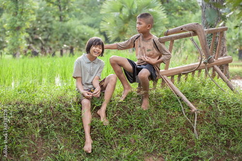 Little boy and girl farmer on green fields. © JKLoma
