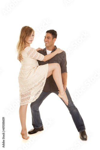 woman in white dress dance with man grab her ankle