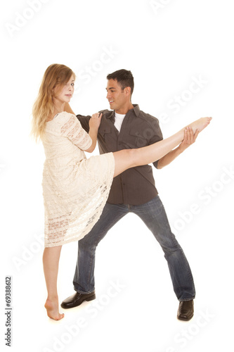 woman in white dress dance with man grab her leg