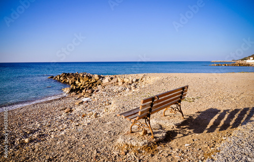 Bench by the water. Aegean sea, Greece © Mangojuicy