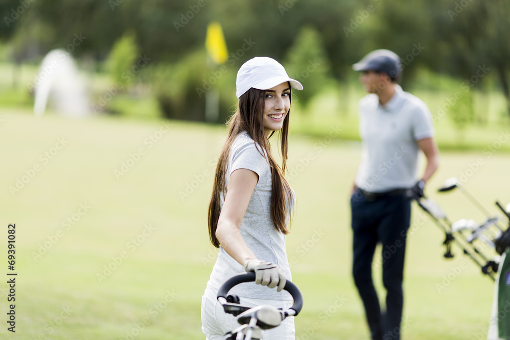 Fototapeta premium Young couple playing golf