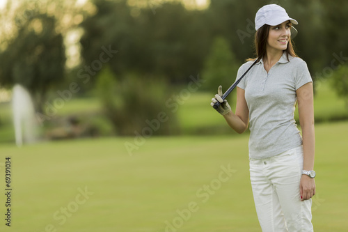 Young woman playing golf