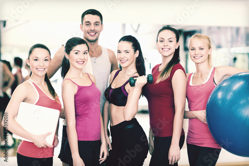 group of smiling people in the gym