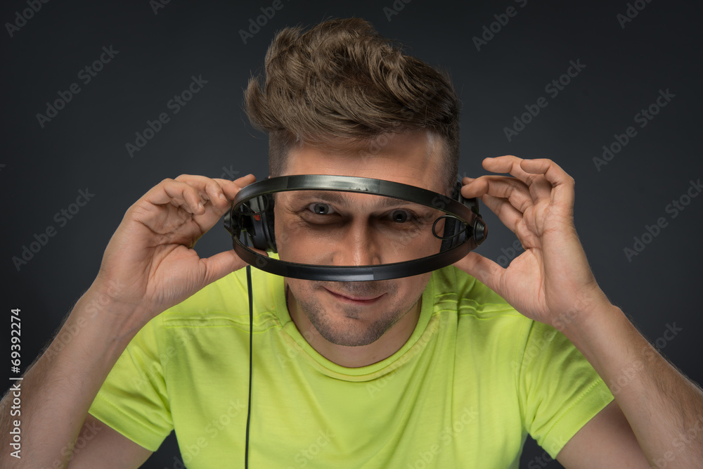 DJ holding his headphones DJ holding his headphones