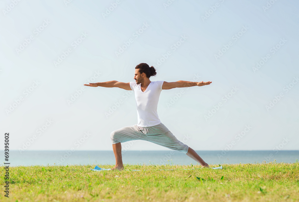 smiling man making yoga exercises outdoors smiling man making yoga exercises outdoors