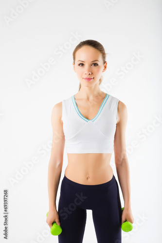 Young girl with dumbbells on a white background © BestForYou