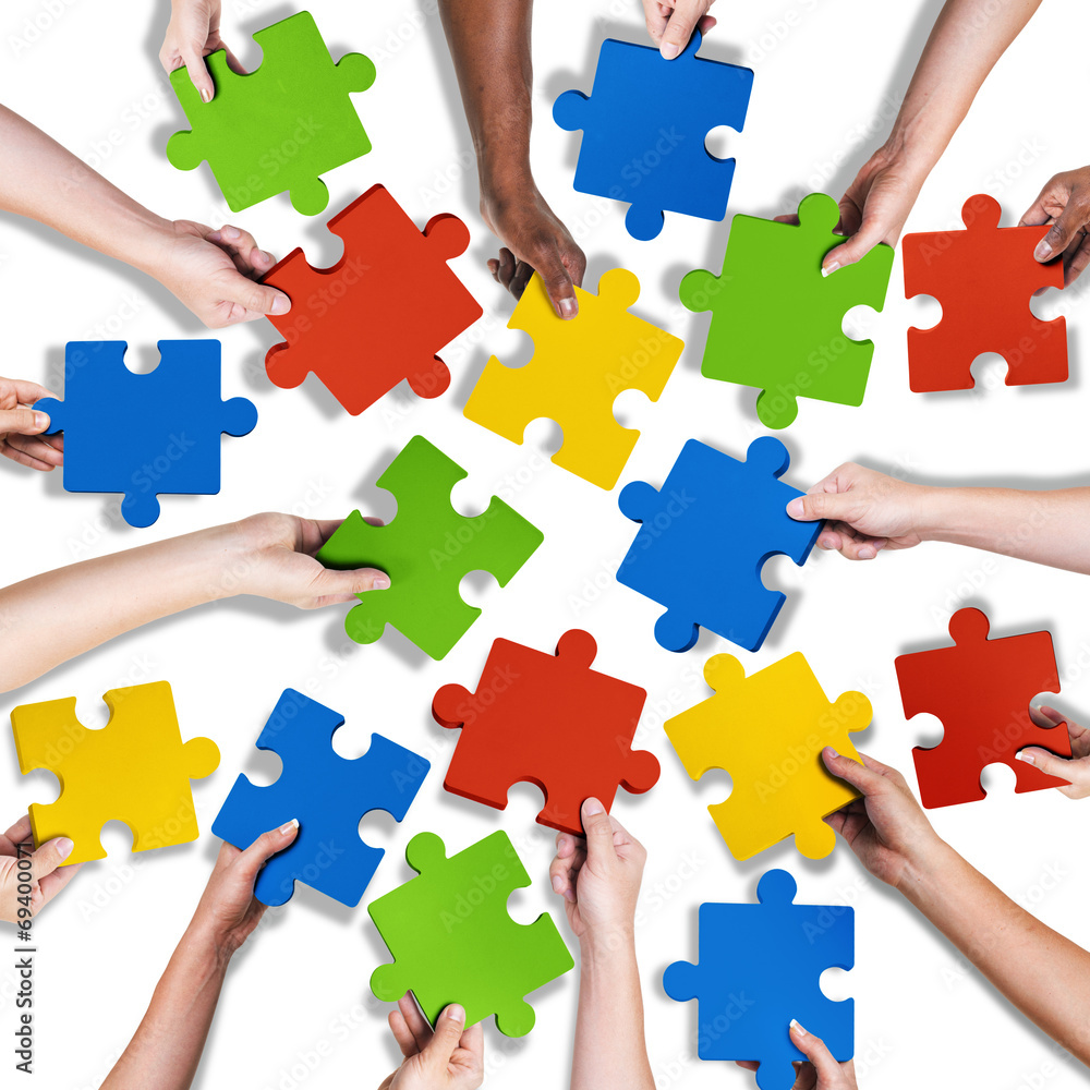 Group of Diverse Hands Holding Jigsaw Puzzle Group of Diverse Hands Holding Jigsaw Puzzle