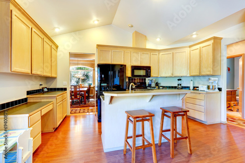 Ivory kitchen cabinets with black appliances