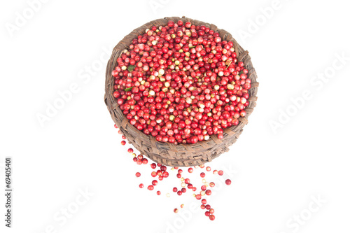 berries a cowberry in the old basket isolated on white backgroun photo