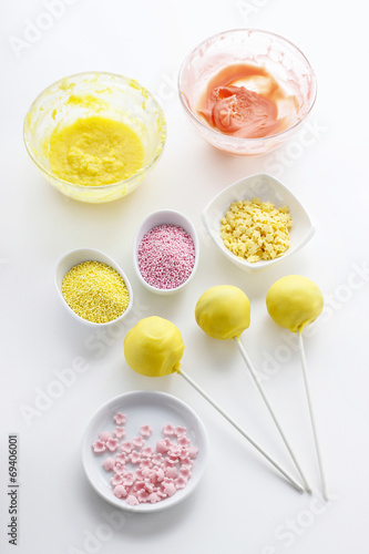Yellow cake pops isolated on white background