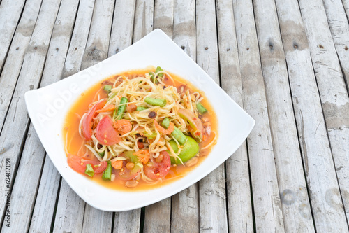 green papaya salad in white dish