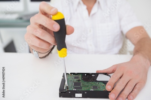 Computer engineer working on broken cpu with screwdriver