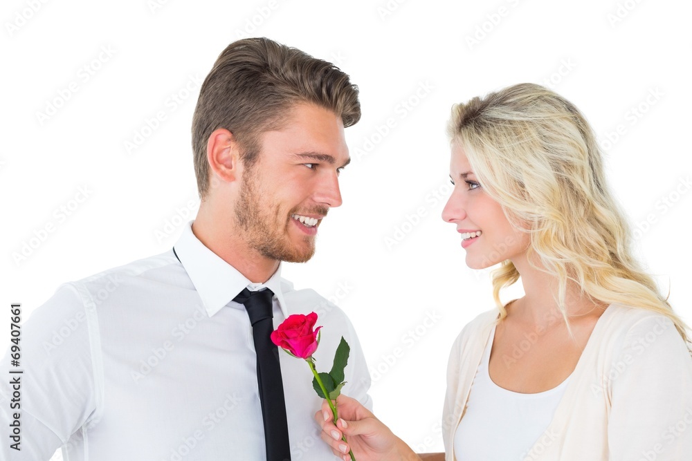Handsome man smiling at girlfriend holding a rose Handsome man smiling at girlfriend holding a rose