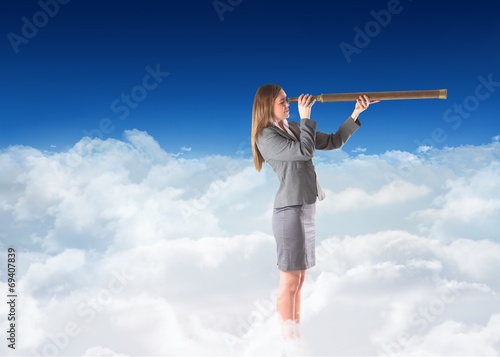 Composite image of businesswoman looking through a telescope © WavebreakMediaMicro