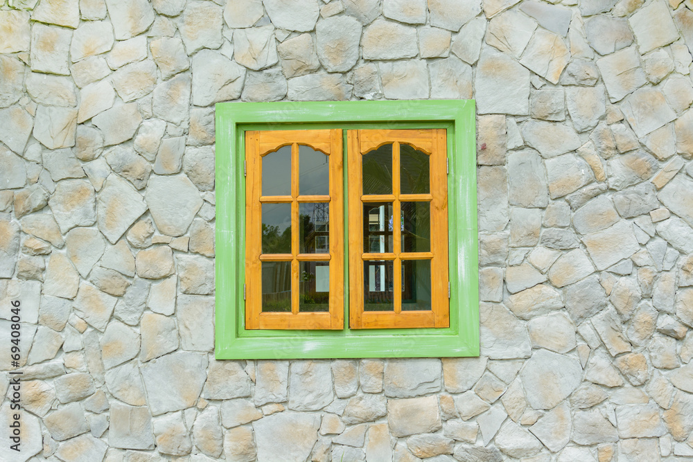 Obraz premium wooden window with stone wall