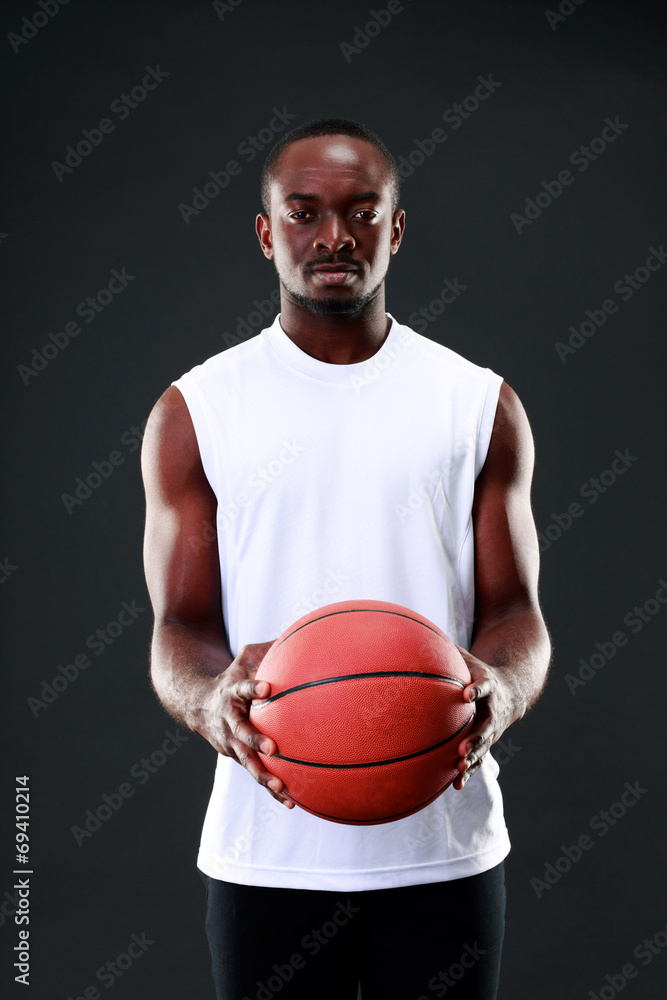 Young african american holding basketball ball Young african american holding basketball ball