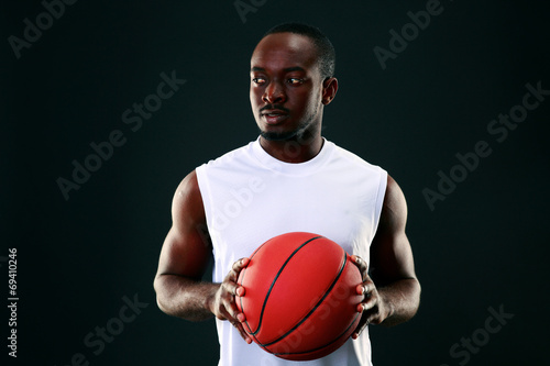 Young african american holding basketball ball