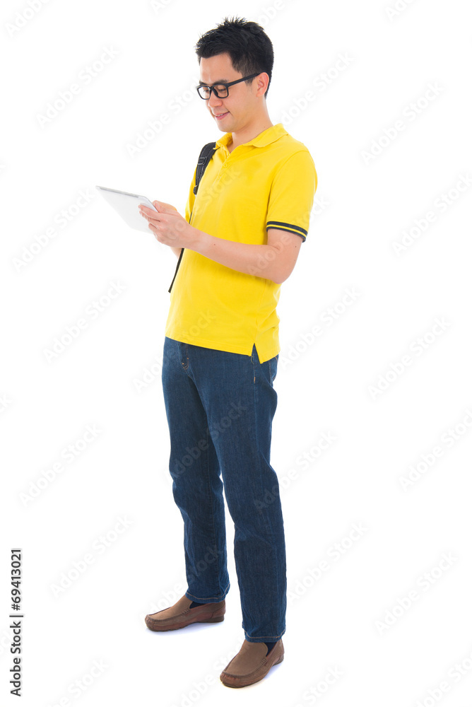 Asian adult student in casual wear with school bag using digital Asian adult student in casual wear with school bag using digital