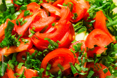 Sliced tomatoes background with green onions