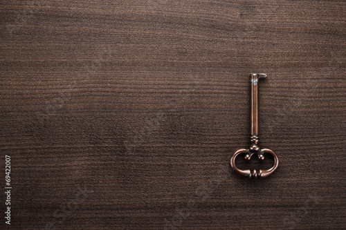 old brass key on wooden table