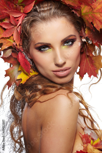 Autumn woman dressed in red leaves